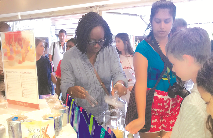  Mrs Nina Kumi (left) Director of Bespoke Travel Consult sampling more than six grades of sugar displayed at the Sugar Museum